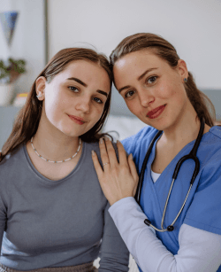 young-nurse-taking-care-of-teenage-girl-consoling-