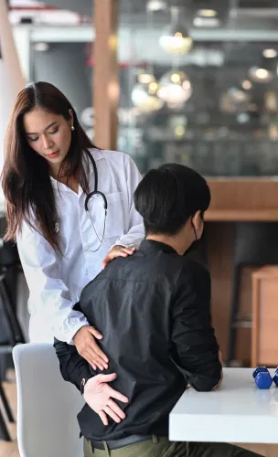 doctor-examine-young-man-with-low-back-pain-2021-12-14-21-37-55-utc 1