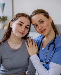 young-nurse-taking-care-of-teenage-girl-consoling-